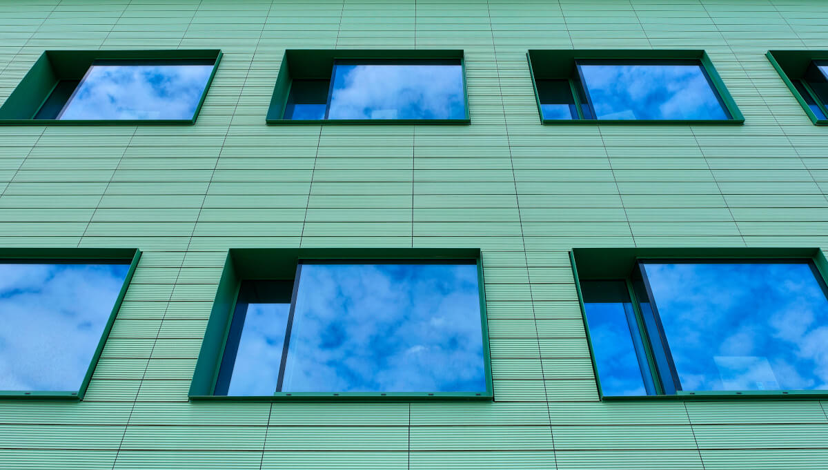 A close-up view of a terracotta tile window facade of the Cadix Clinic building in Antwerp, showcasing the durability and aesthetics of Tonality terracotta tiles