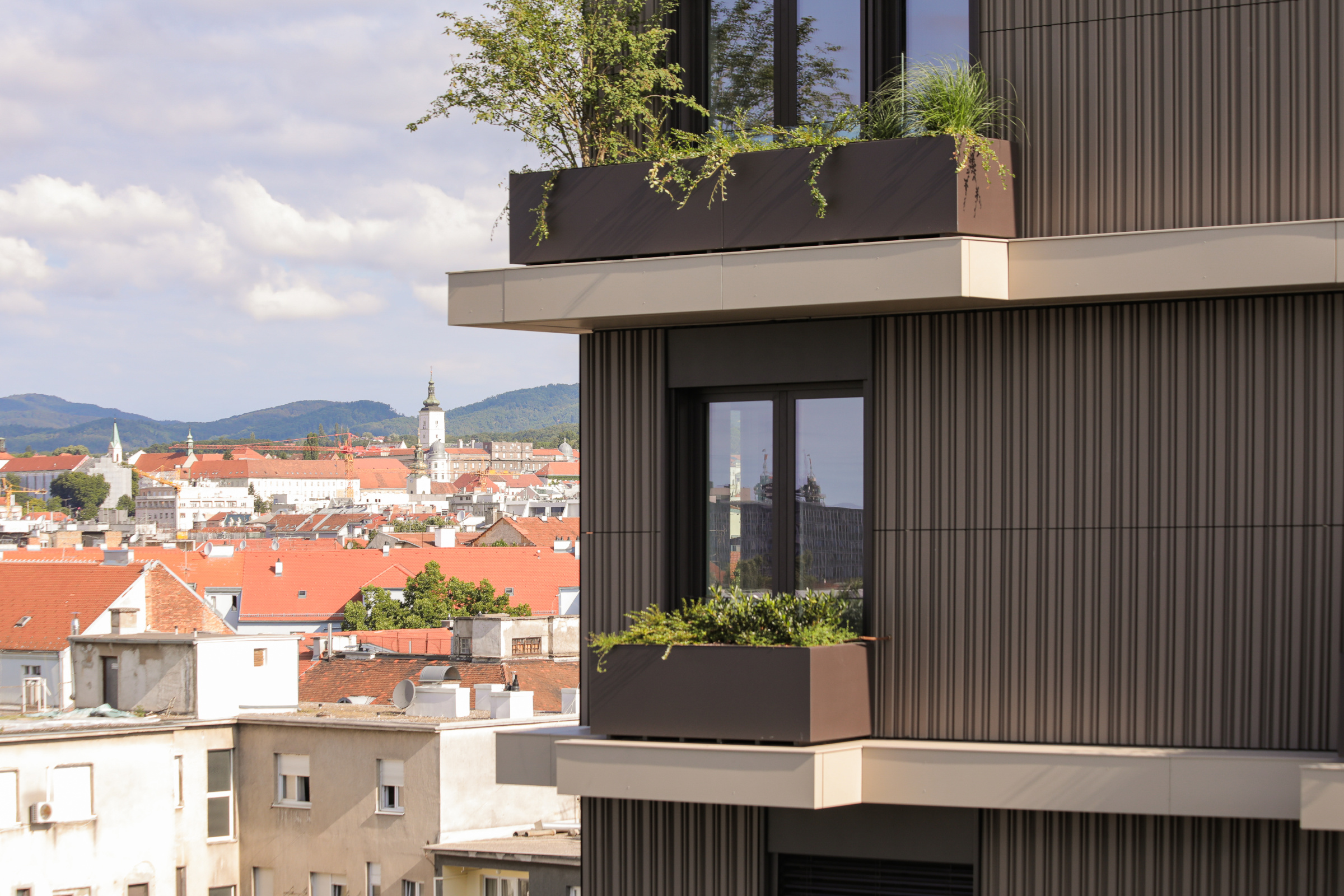 Terracotta ceramic facade as reference to Montano residential building - side view