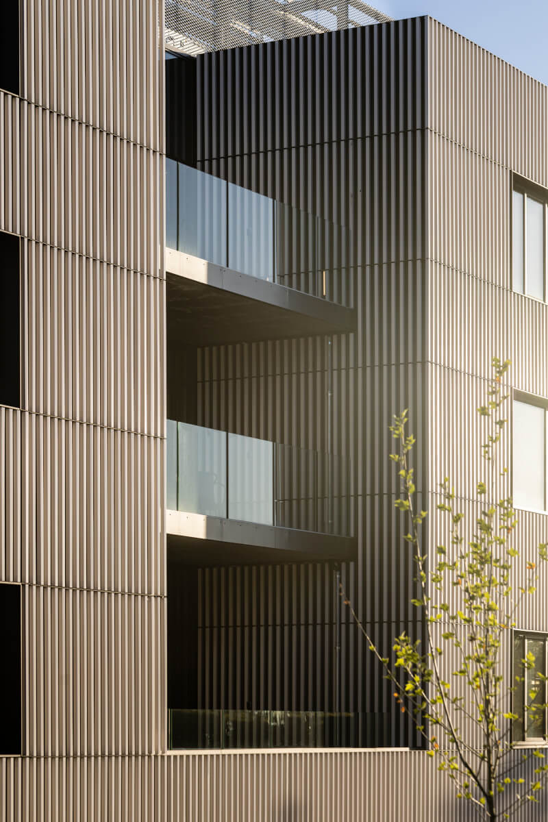 Close-up view of square terracotta facade at Velliv Ballerup Office in Denmark - tonality reference