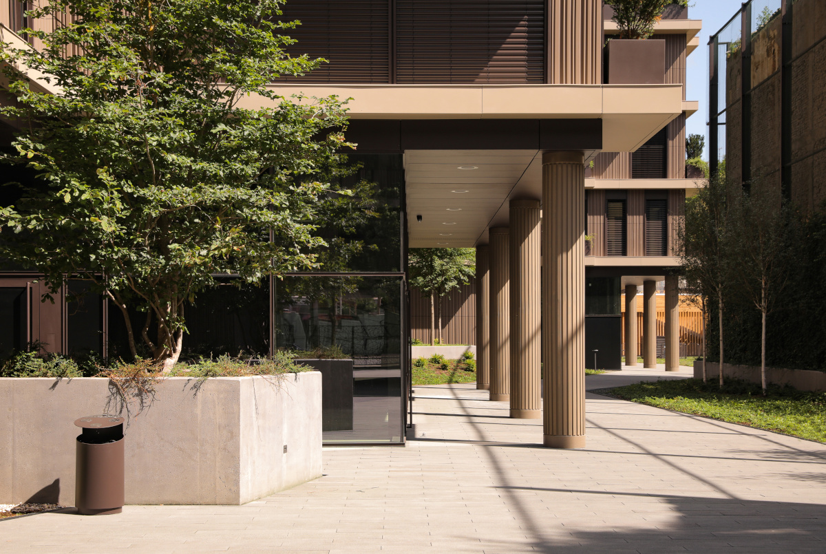 Vertical terracotta ceramic facade at Montano residential building entry - Inviting and sustainable building design using high-quality ceramic materials